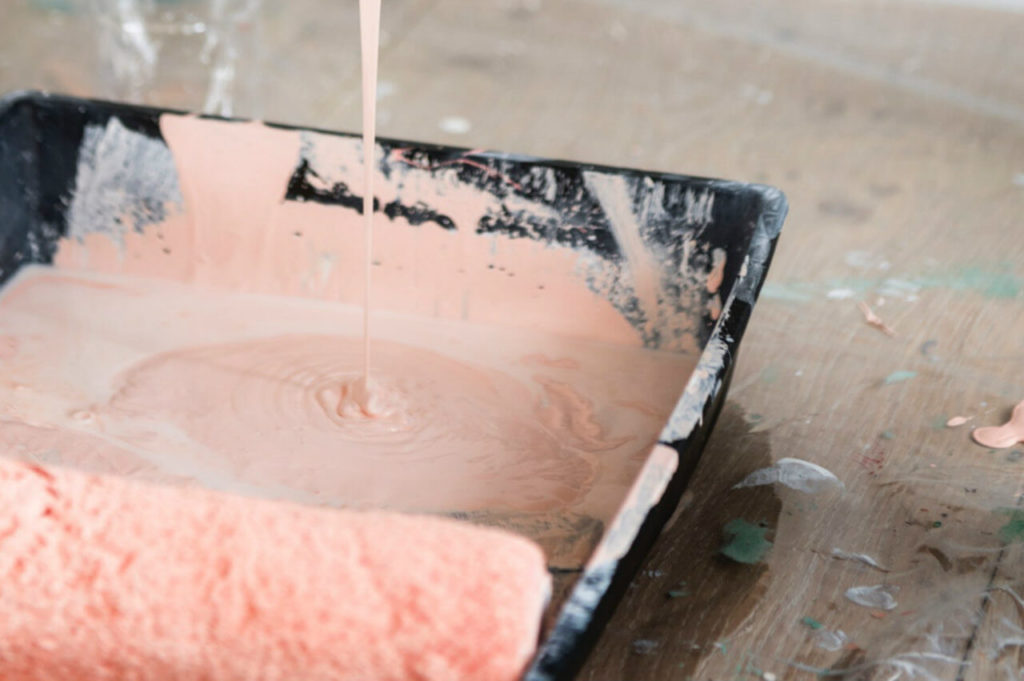 pink paint with roller and tray