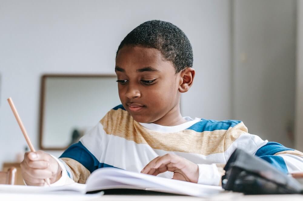 boy doing homework | resilient, confident, motivated kids | This Time Of Mine