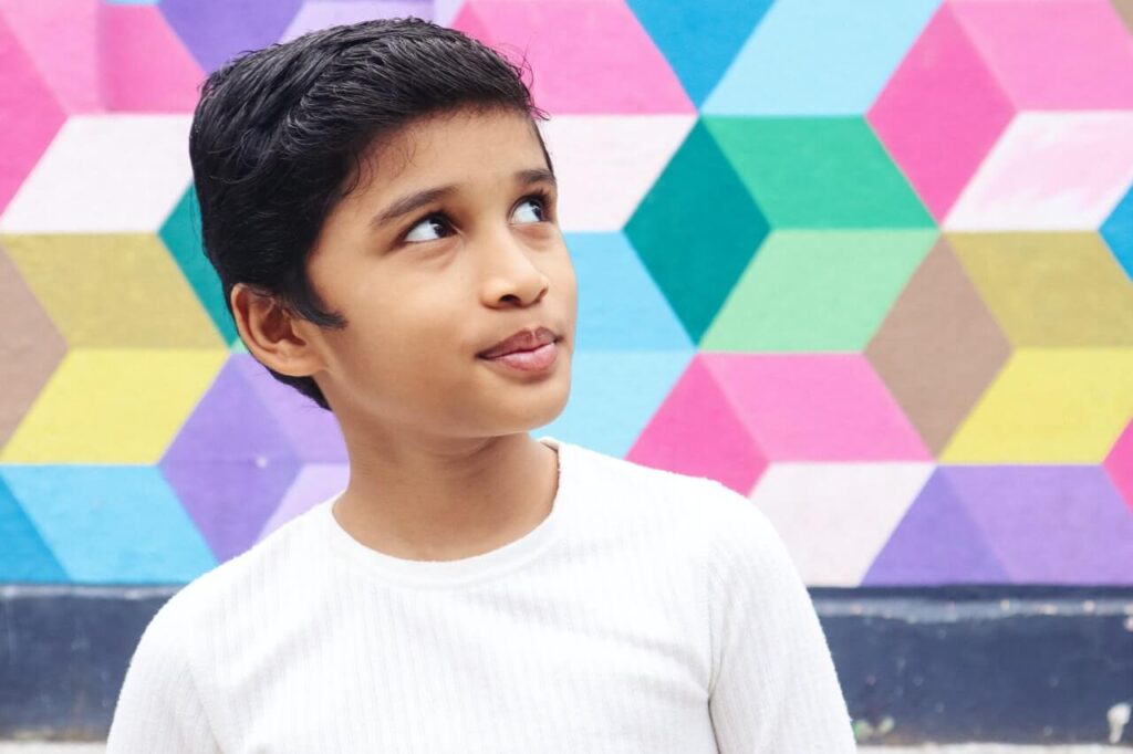 boy in front of colorful wall | This Time Of Mine