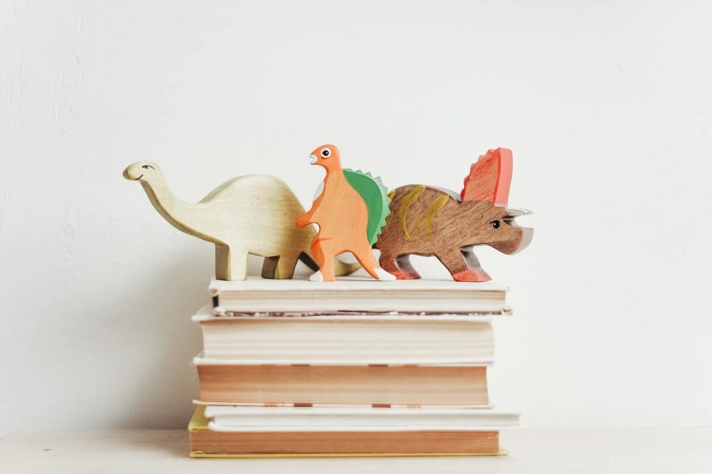 toy dinosaurs on books | daily schedule during school closures | This Time Of Mine